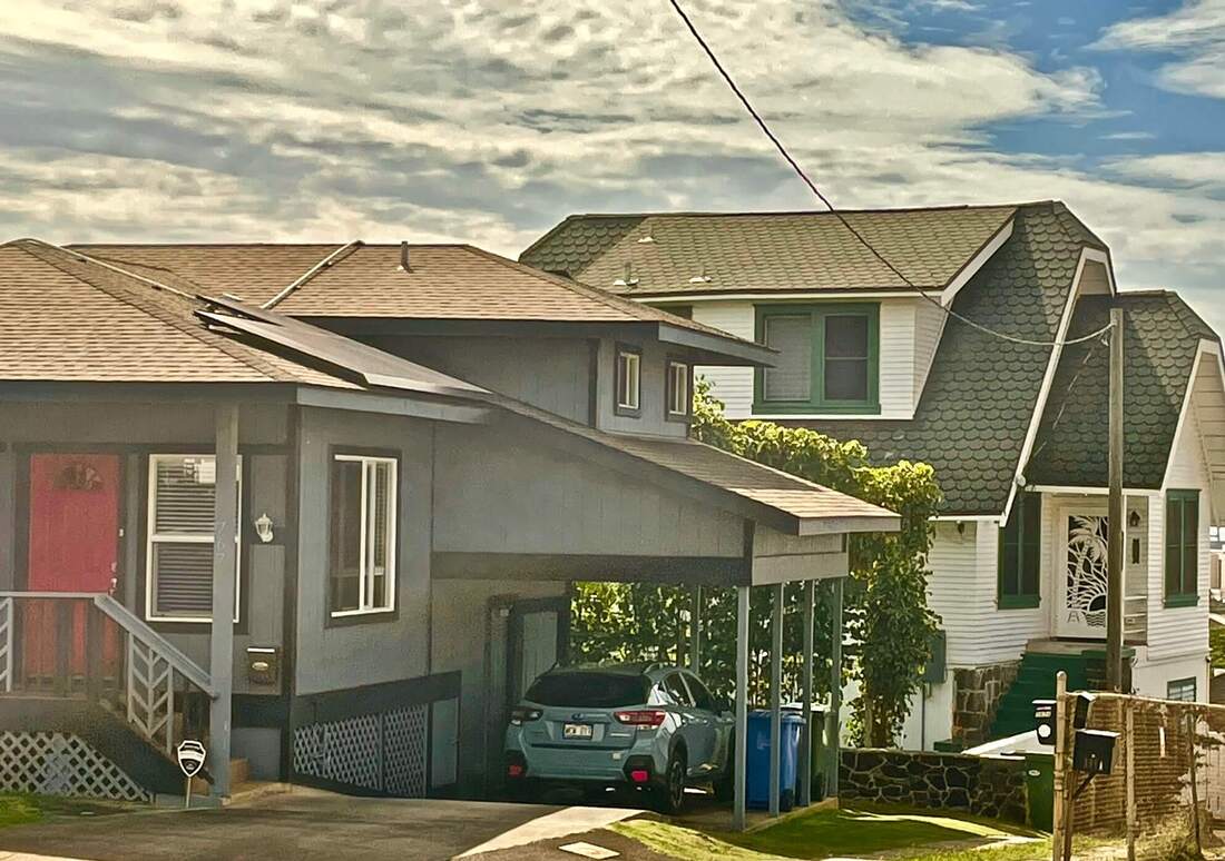 2 houses with asphalt shingle roofs